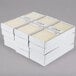 A stack of ivory Hyoola taper candle boxes.
