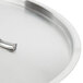 A close up of a stainless steel Vollrath pan lid with a handle.