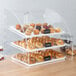 A Vollrath bakery display case with bagels and pastries inside.