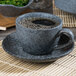 A cup of coffee on a Biseki blue stoneware saucer.