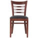 A Lancaster Table & Seating mahogany wood chair with black vinyl cushion