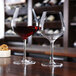 Two Chef & Sommelier Cabernet wine glasses filled with red wine on a table.