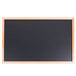 An Aarco black chalk board with an oak frame.