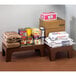 A brown Cambro dunnage rack with a box of food on top of it.