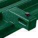 A green plastic Cambro tray rail on a table.