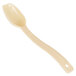A close-up of a Cambro beige salad bar spoon with a cream colored handle.