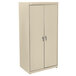 A putty HON storage cabinet with two doors and silver handles.
