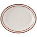 A white plate with brown speckled narrow rim.