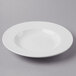 A Libbey Basics Orbis bright white porcelain pasta bowl with a circular rim on a white surface.