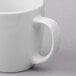 A close-up of a Libbey Bright White porcelain mug with a handle.