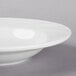 A Libbey bright white porcelain soup bowl with a wavy rim.