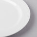 A close-up of a Libbey bright white porcelain plate with a thin rim.