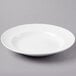 A Libbey bright white porcelain entree/pasta bowl on a white surface.