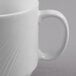 A close-up of a Libbey bright white stacking mug with a handle.