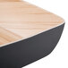 A Tablecraft black melamine bowl with bamboo accents.
