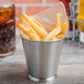 A Clipper Mill stainless steel mini pail filled with French fries.