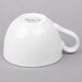 A Libbey Basics bright white porcelain low tea cup with a handle.