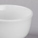 A close up of a Libbey Bright White Porcelain Bouillon bowl with a lid.