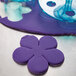 A purple flower shaped pastry cutter from an Ateco rose cutter set.