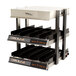 A Global Solutions by Nemco heated countertop merchandiser with two slanted shelves holding trays.