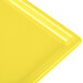 A close-up of a yellow Tablecraft rectangular cooling platter.