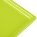 A lime green Tablecraft cast aluminum rectangular cooling platter.