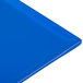 A close-up of a cobalt blue Tablecraft cast aluminum rectangular cooling platter.