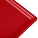 A red Tablecraft cast aluminum rectangular cooling platter.