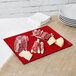 A red Tablecraft rectangular cast aluminum tray with meat and cheese.