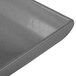 A close up of a grey granite cast aluminum rectangular platter with a flared edge.