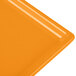 An orange cast aluminum rectangular cooling platter with a flat bottom and orange corners.