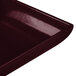 A maroon speckled rectangular metal platter with a flared rim.
