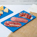 A Tablecraft sky blue cast aluminum rectangular tray with meat and cheese on a table.