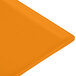 An orange cast aluminum rectangular cooling platter.