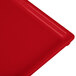 A close-up of a red Tablecraft rectangular cooling platter with a handle.