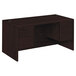 A dark brown HON 3/4 height double pedestal desk with drawers.
