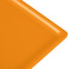 A close-up of an orange Tablecraft rectangular cooling platter.
