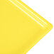 A yellow cast aluminum rectangular cooling platter with a white surface.