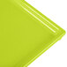 A close-up of a lime green Tablecraft rectangular cooling platter.
