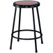 A black National Public Seating lab stool with a round wooden seat.