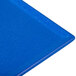 A blue speckled cast aluminum rectangular cooling platter on a table.