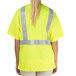 A person wearing a yellow Cordova high visibility safety shirt with reflective stripes.