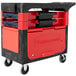 A black Rubbermaid TradeMaster cart with a red handle and locking cabinet.