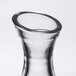 A close up of a Stolzle clear glass carafe with a pour line.