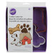 A package of Wilton metal cookie cutters including a dog, dog bone, and paw print cookie cutters.
