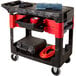 A black Rubbermaid TradeMaster cart with 2 parts boxes and 4 parts bins on 2 shelves.
