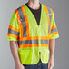 A man wearing a Cordova lime high visibility safety vest with reflective tape smiles.