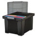 A black Storex plastic file storage box with colorful files inside.