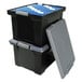 A stack of black Storex portable file storage boxes with blue file folders inside.