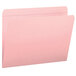 A close-up of a Smead pink file folder with a paper inside.